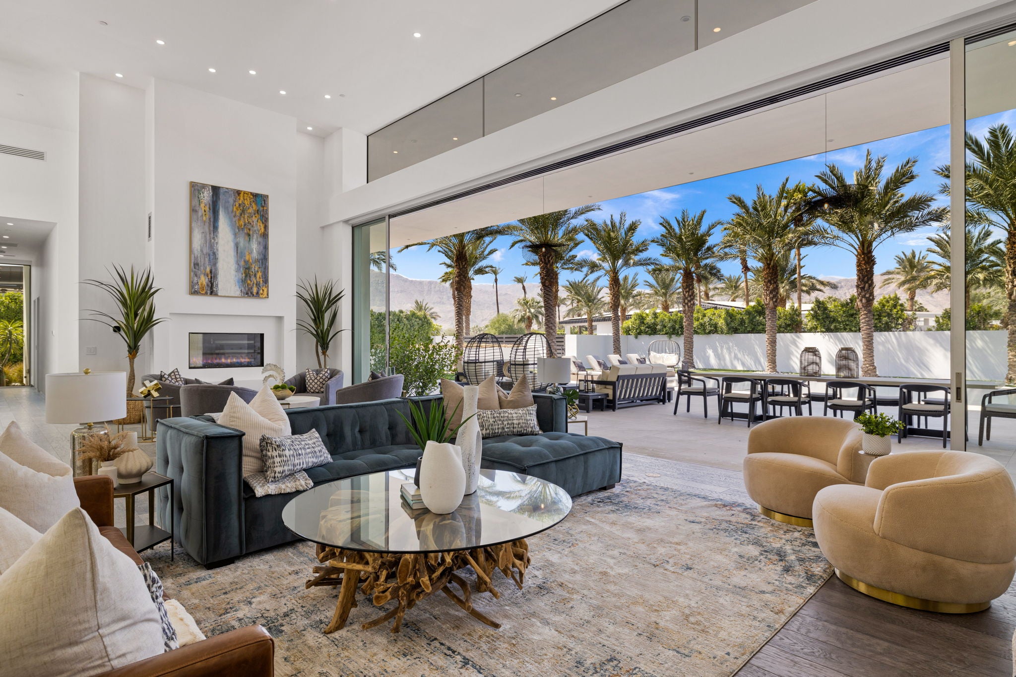 Simply Staging - Living Room Decor including couch, chairs, coffee table, views of outdoor furniture.