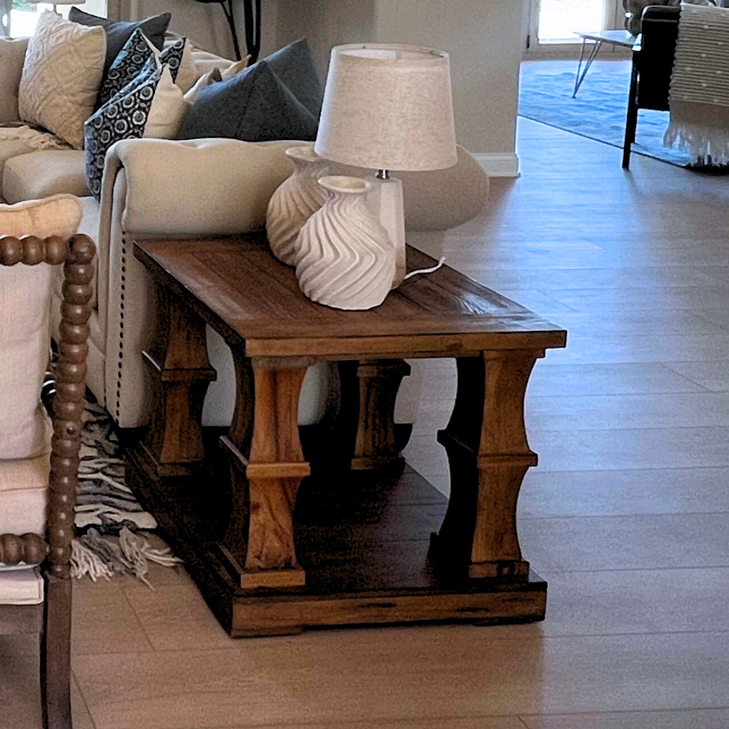 Wooden side table with a lamp in a living room setting