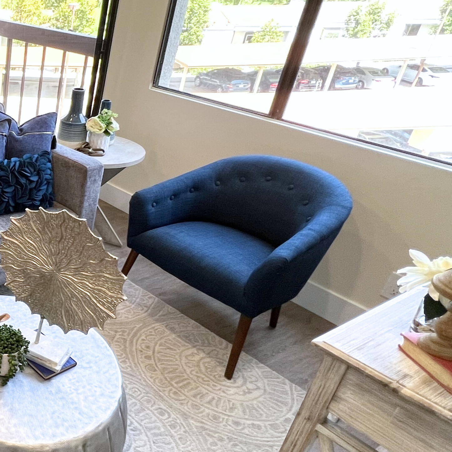 Navy blue armchair in a living room with decorative elements.