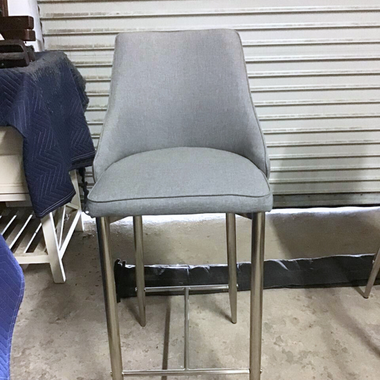 grey fabric barstool in warehouse