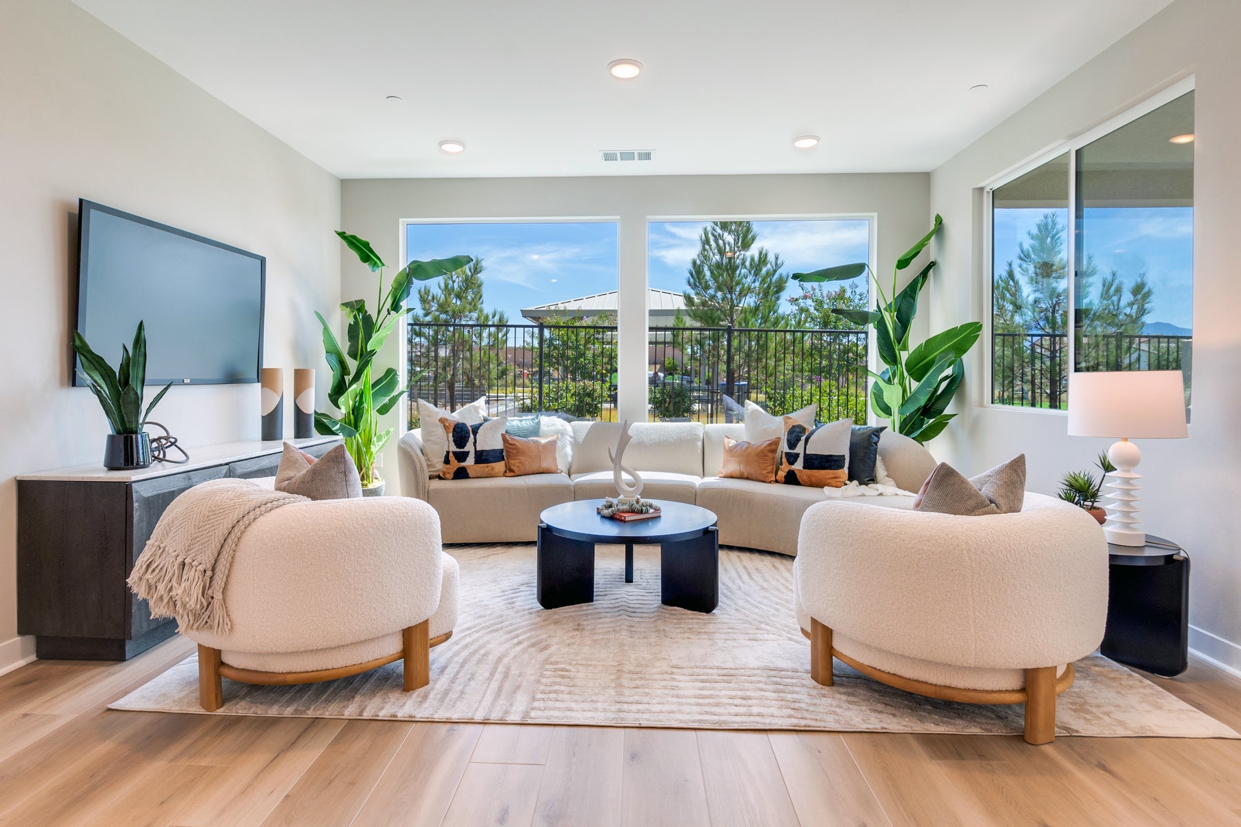 Modern living room with beige sofa, armchairs, and a coffee table.
Details