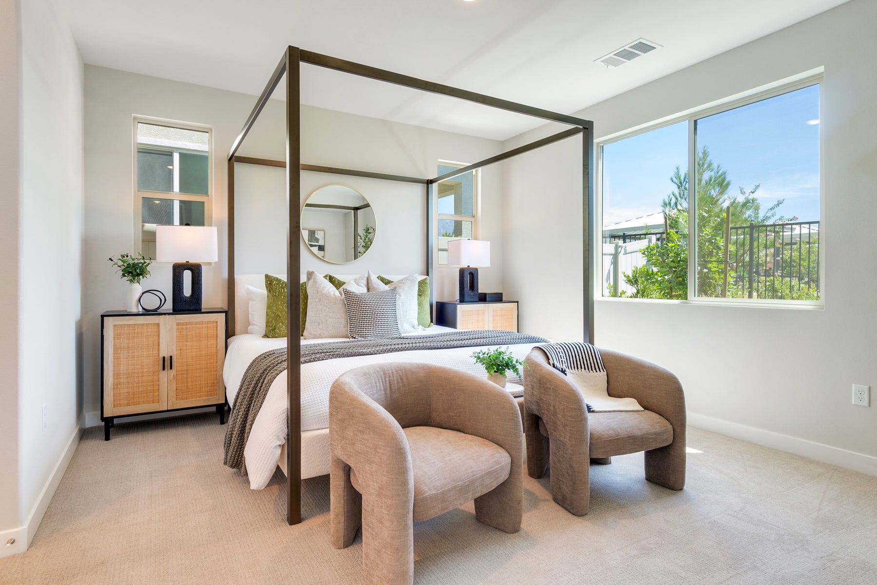 Modern Bedroom with metal framed bed, two side chairs and nightstands.
