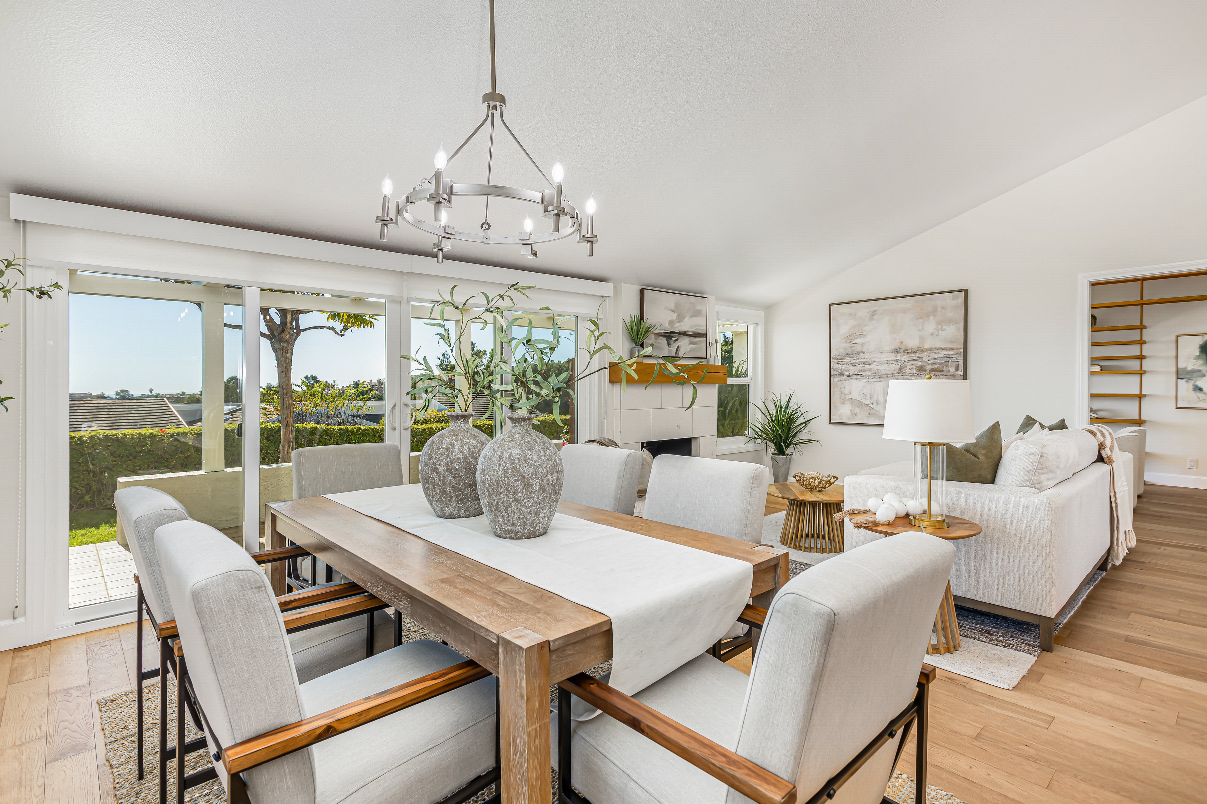 modern dining area with cream chairs and wooden table. 