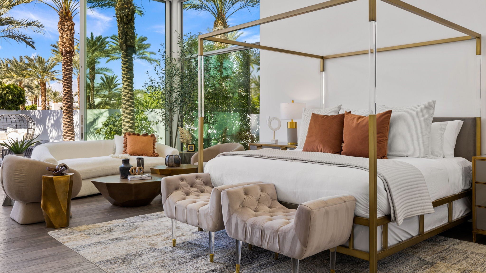 Modern bedroom - bed with posts, sitting area, creams, naturals and rusts. 