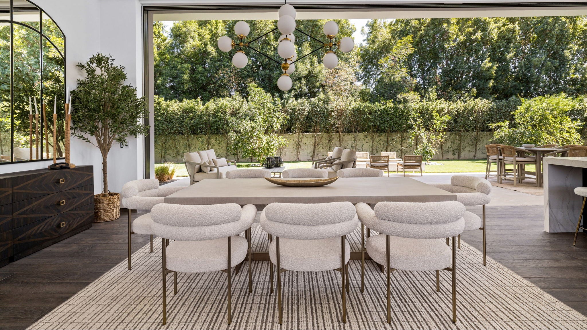 Modern dining area with a large window view of greenery