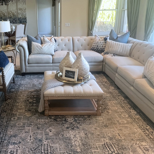 Cream Tufted Ottoman in a staged living room
