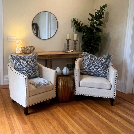 Cream nailhead accent chair in a staged living room