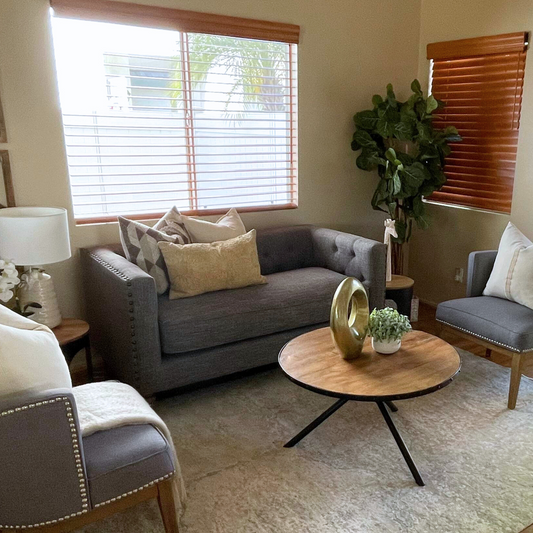 Grey nailhead loveseat in a staged living room