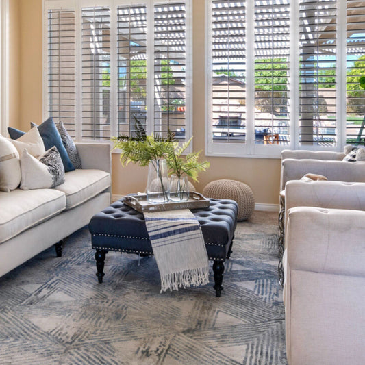 Grey Tufted Ottoman Coffee Table in a staged living room