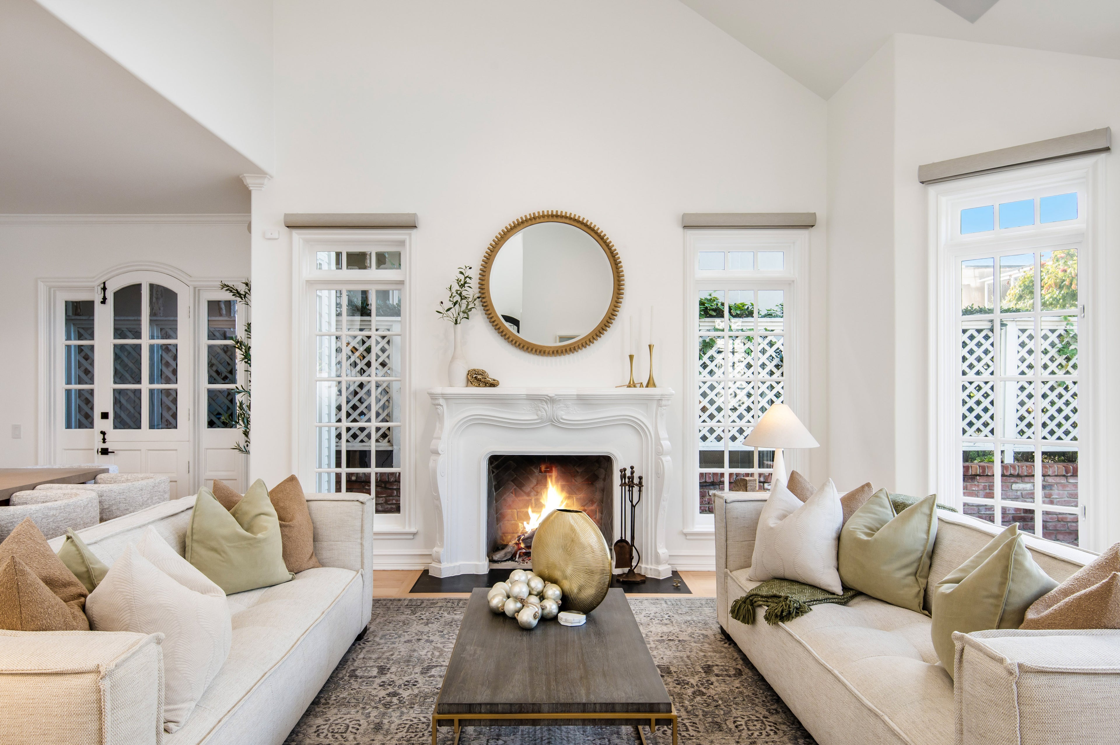 Living room with white walls, a fireplace, and decorative elements.