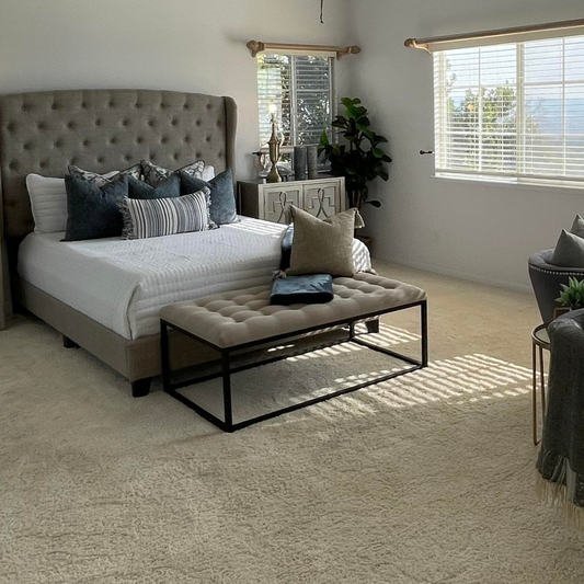 Light Grey Tufted Bench in a staged bedroom