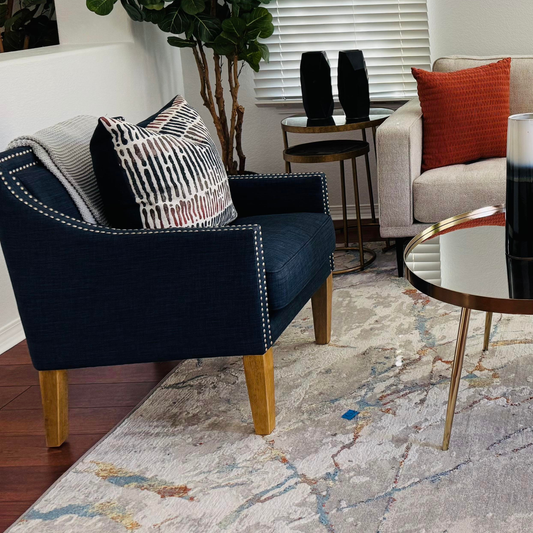 Navy blue and silver accent chair in a staged living room 