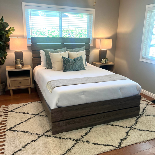 Queen brown wooden bed frame in staged bedroom