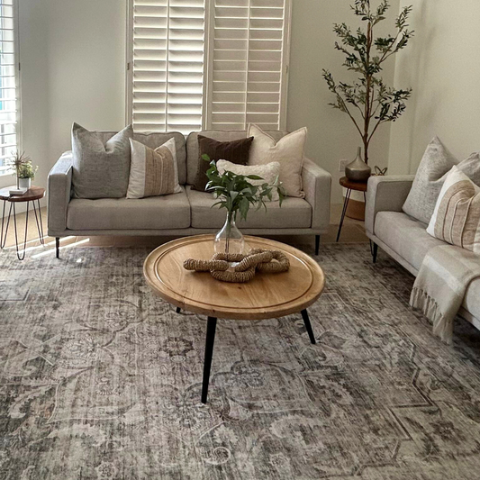 Living room with gray sofas, wooden coffee table, and decorative elements.