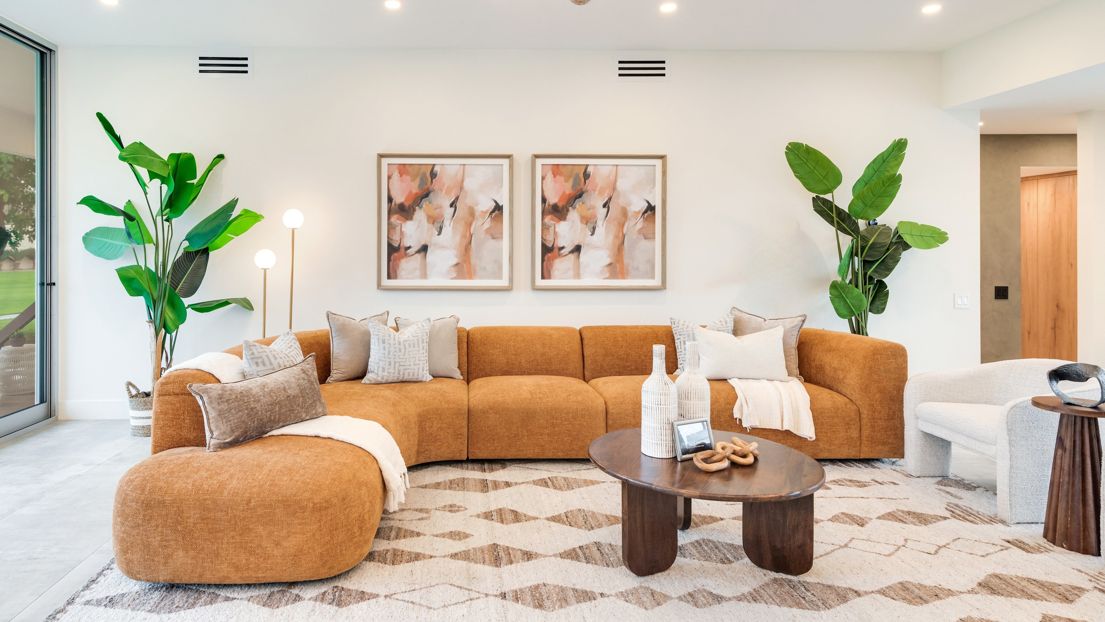 Modern living room - rust couch, oranges, and pinks. 