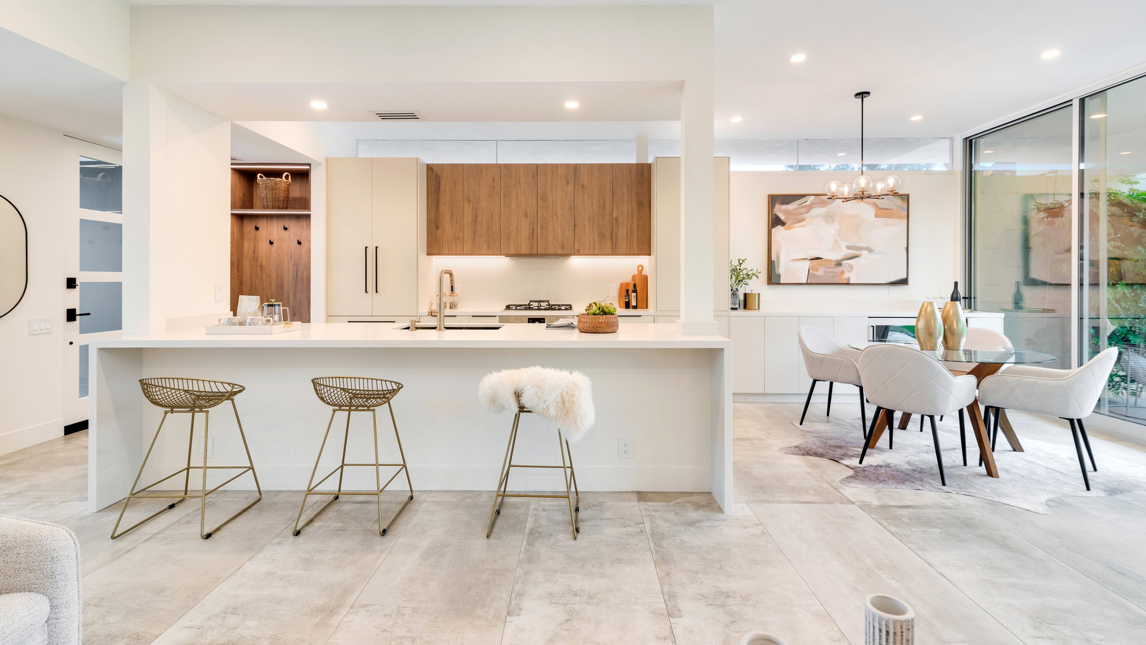 modern kitchen & dining - gold barstools, white chairs with wooden dining table. 