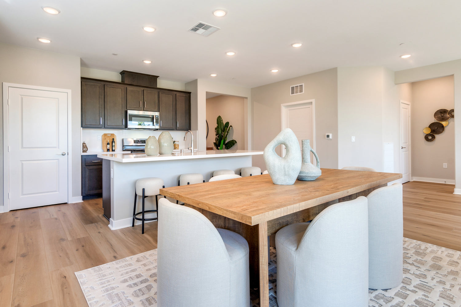 Modern kitchen with wooden dining table and white chairs