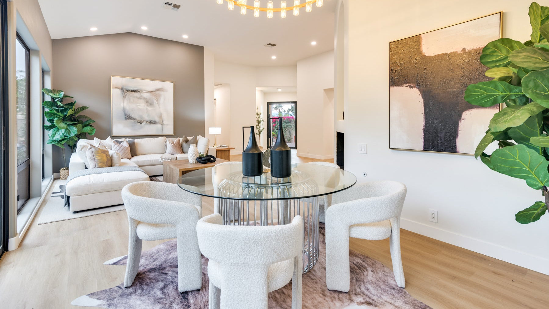 Modern dining room - cream chairs, glass table, decor. 