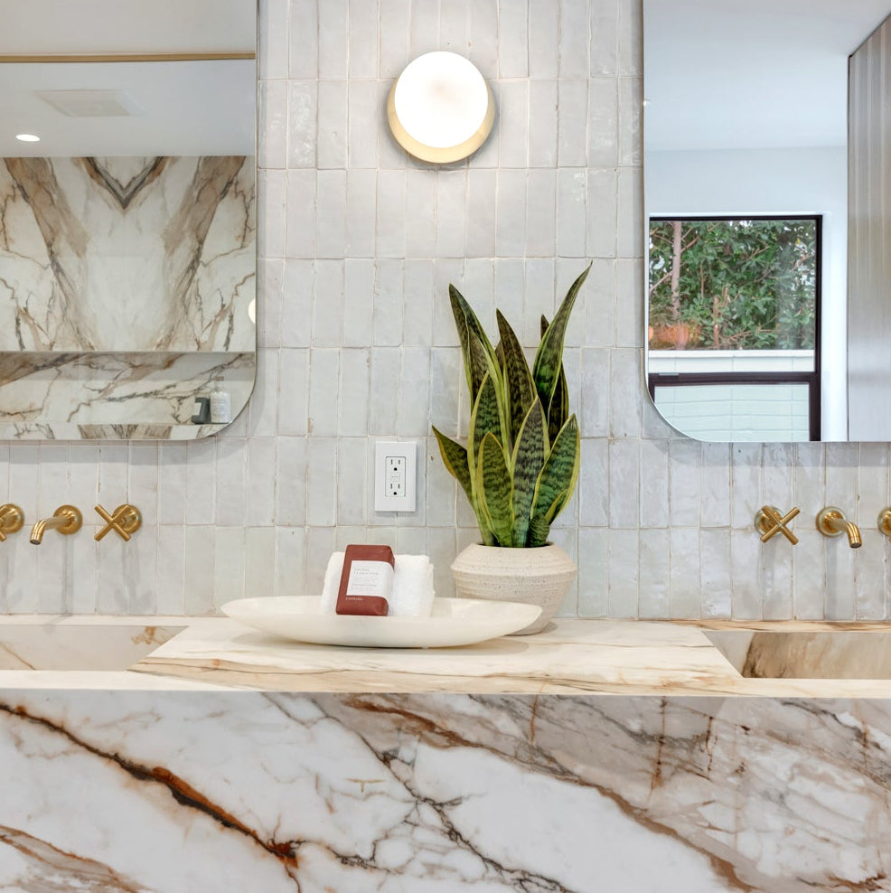 modern bathroom with granite counter tops - staged with soaps, plants, and decor. 