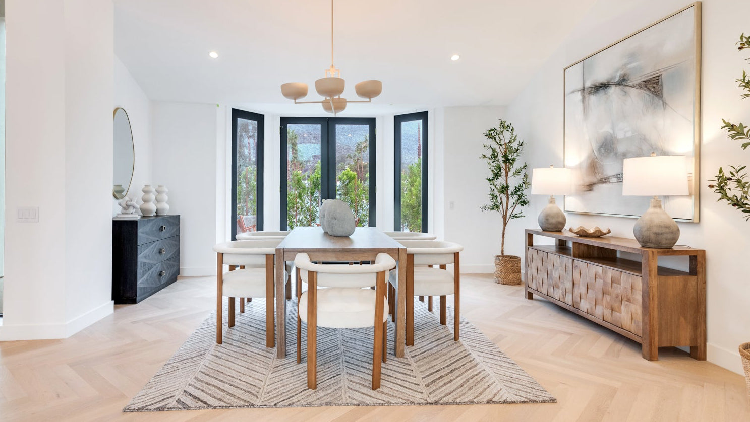 Modern dining room - cream and wood chairs, wood wining table, wood console table with large abstract art. 