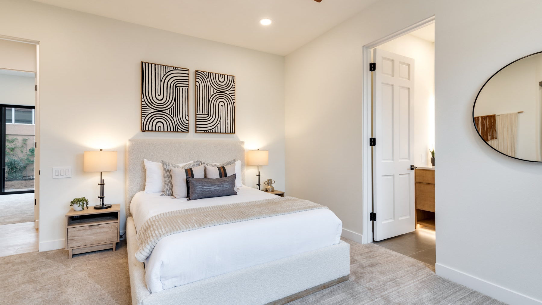 Modern bedroom - bright, cream bed, black and white art - 